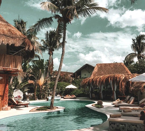 Thatched villas around the lagoon pool