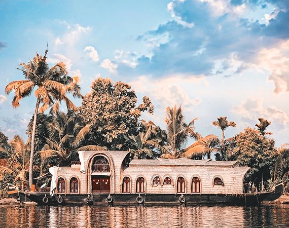A palace on the water behind palm trees