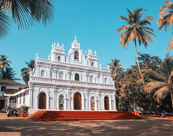 A whitewashed church facade under a blue sky