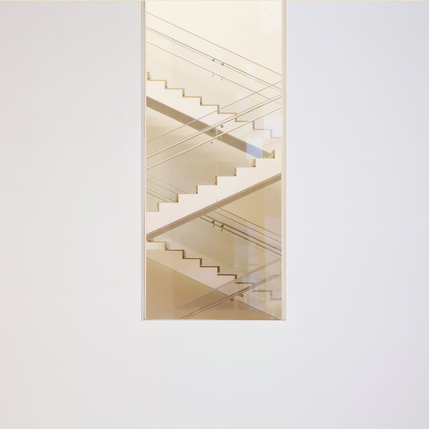 Light Well House by Ferro Lund, a stair seen through a slot in a white wall