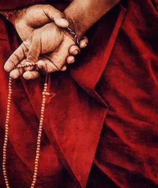 Hands holding prayer beads
