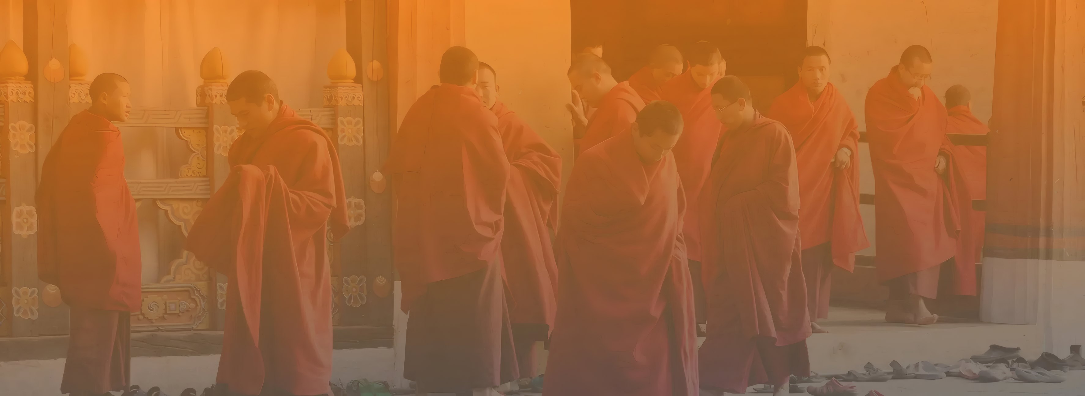 Monks in maroon robes walking through the monastery