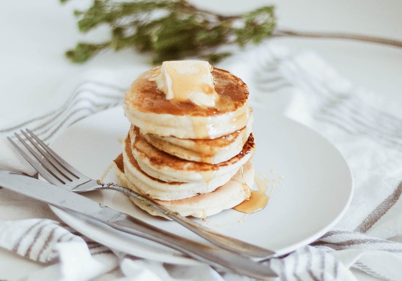 A stack of buttermilk pancakes with berries