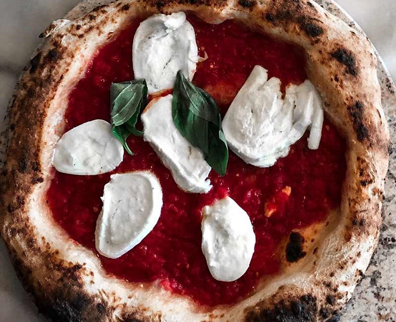 Sauce and fresh mozzarella on a pie