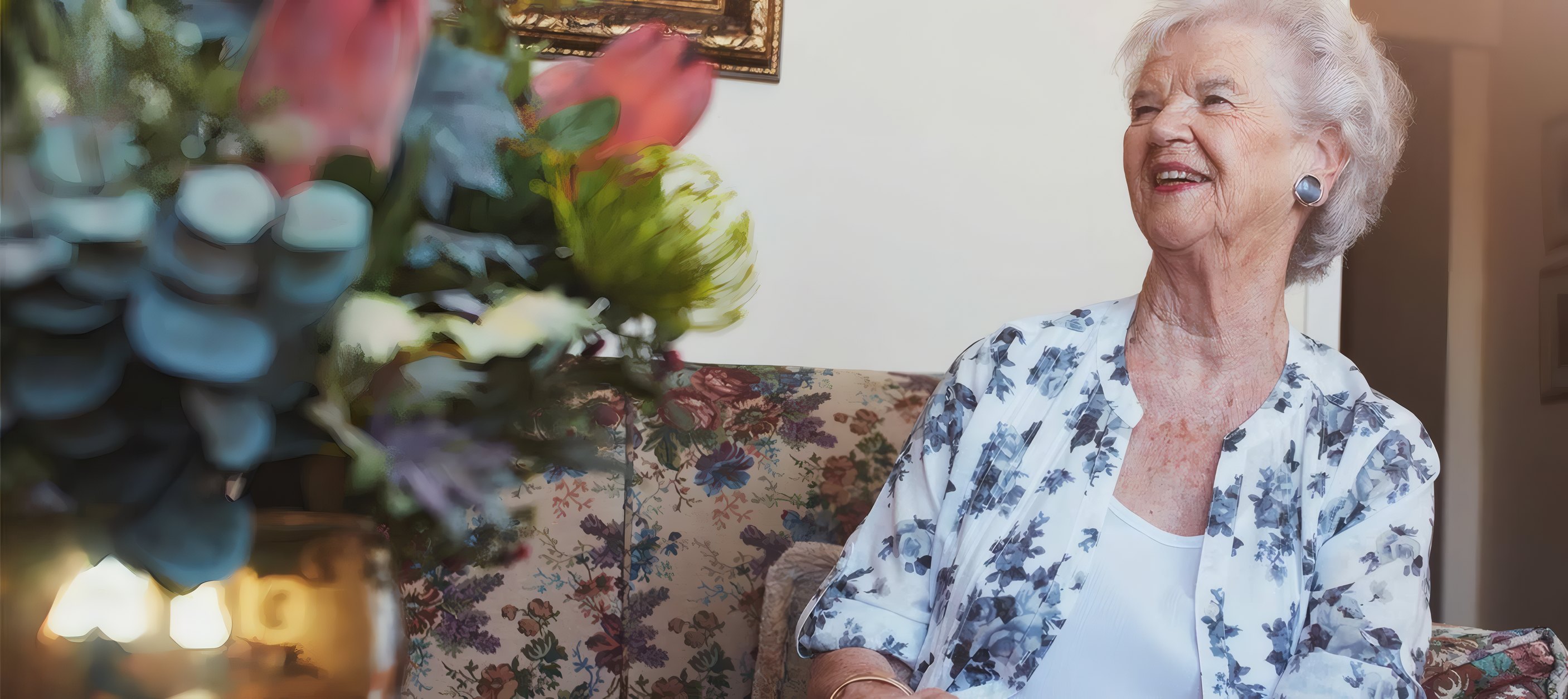 A resident laughing on the sofa at home