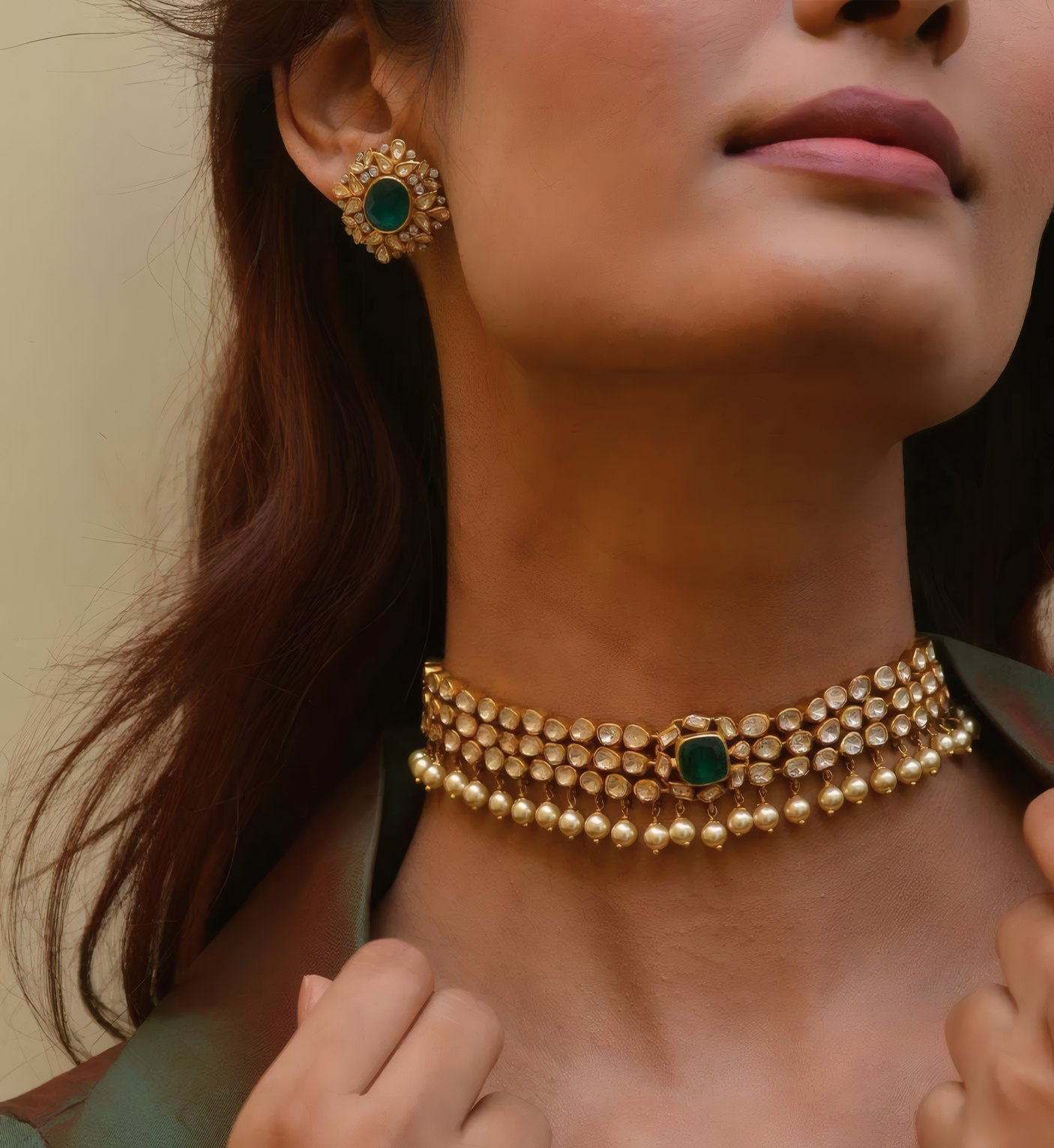 A woman in a gold and emerald choker