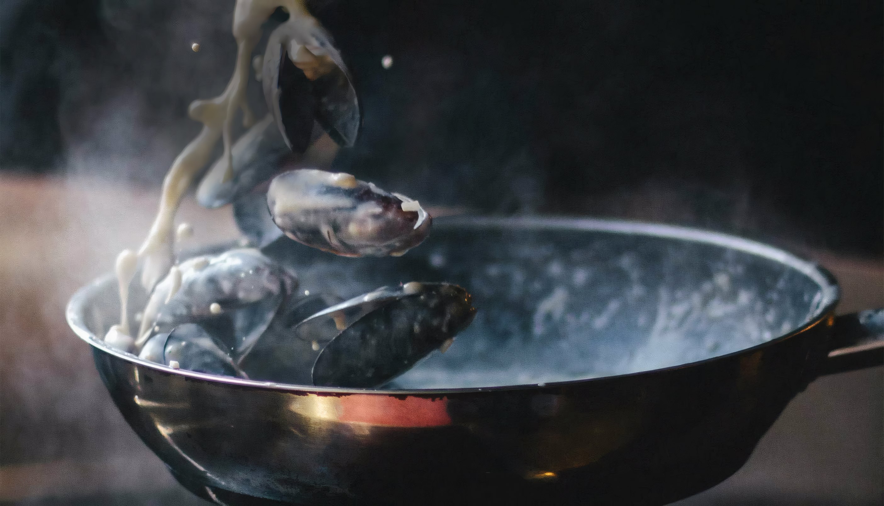 Mussels lifted from a steaming pan