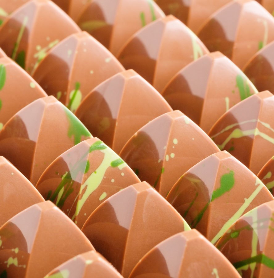 Rows of glossy painted bonbons