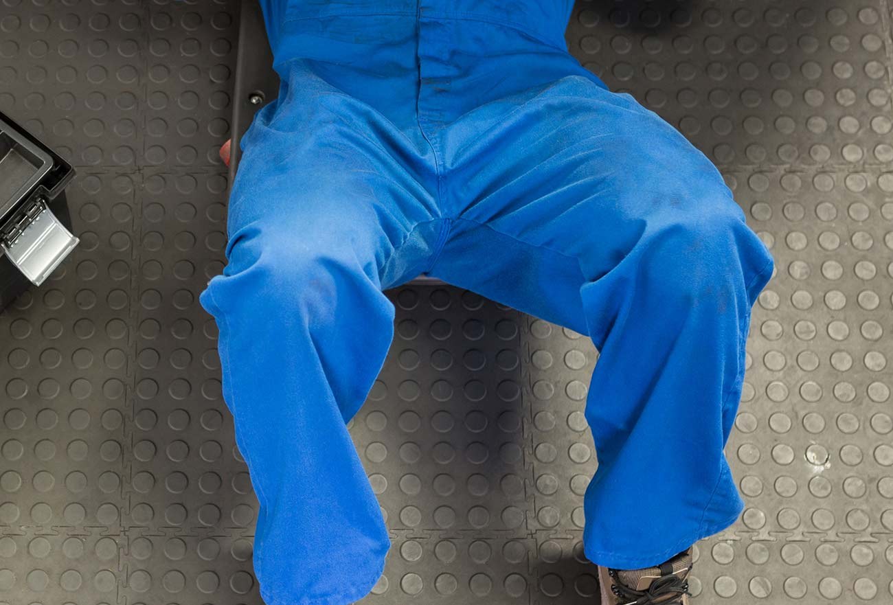 A mechanic under a car