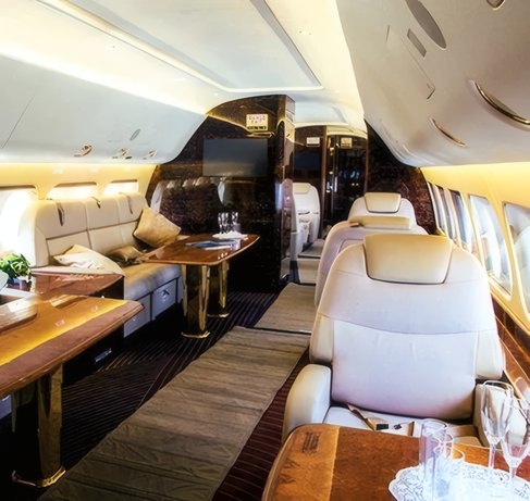A cabin with leather seats and a walnut table