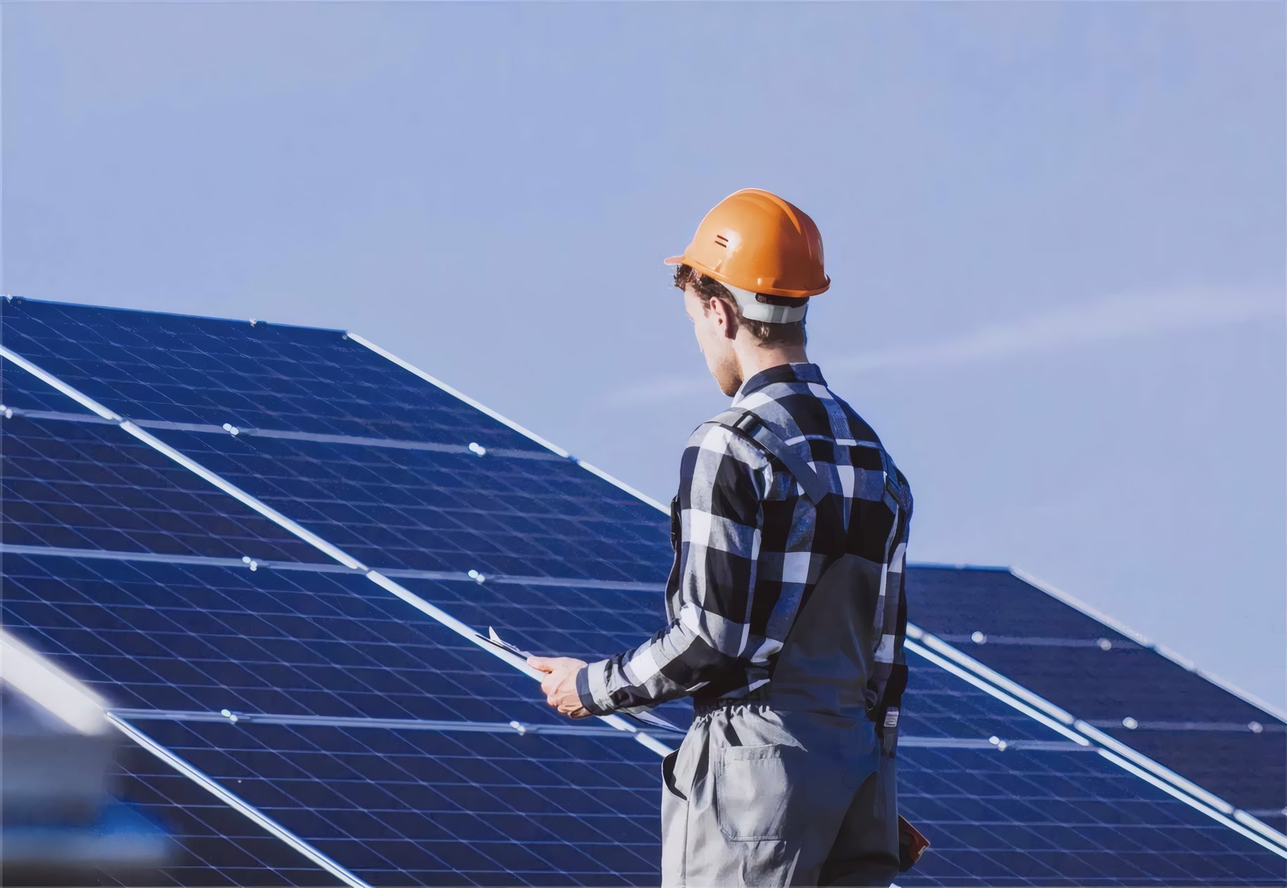 An installer checking the modules on a roof